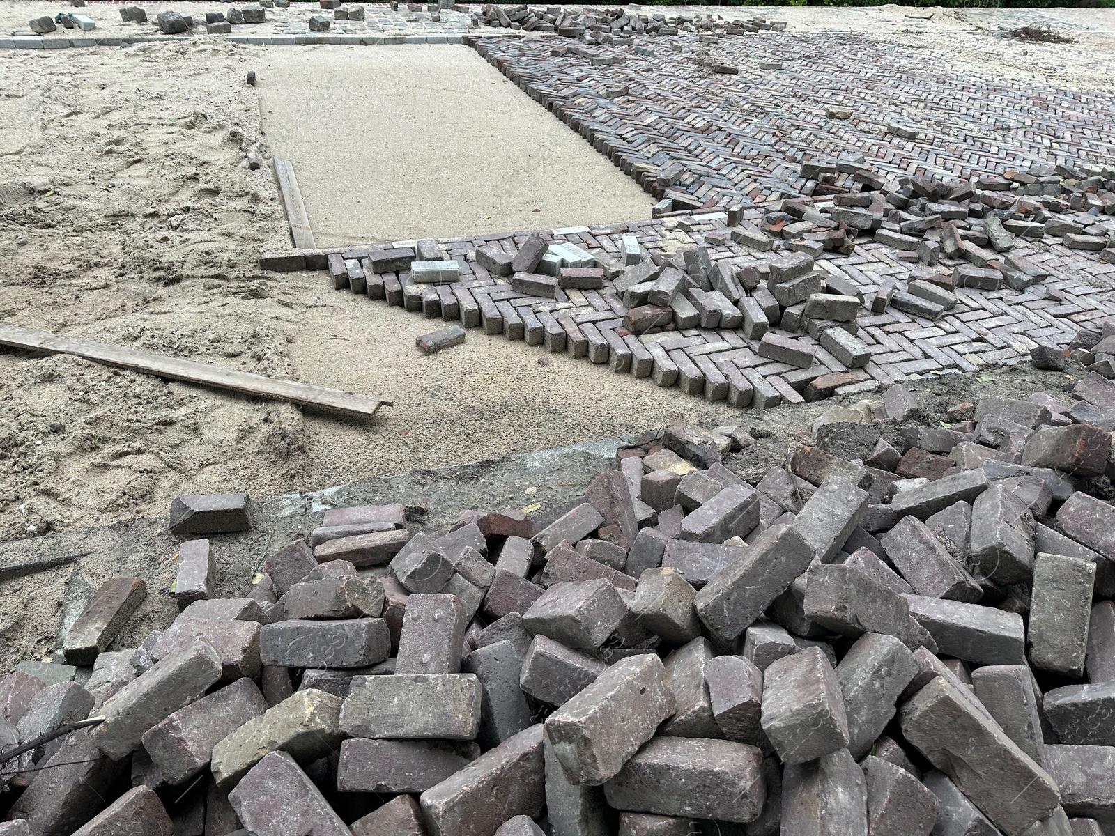 Photo of Process of laying paving stone blocks outdoors