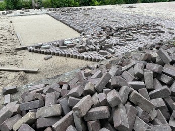 Photo of Process of laying paving stone blocks outdoors