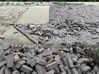 Photo of Process of laying paving stone blocks outdoors