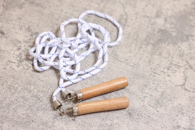 Photo of Skipping rope on grey table. Sports equipment