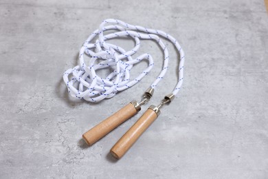 Skipping rope on grey table. Sports equipment