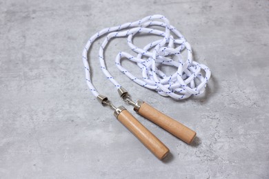 Photo of Skipping rope on grey table. Sports equipment