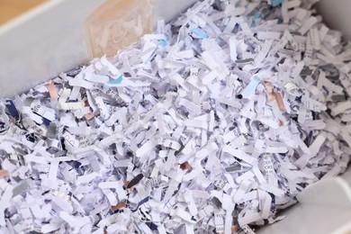 Photo of Shredded paper strips in bin, closeup view