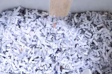 Shredded paper strips in bin, closeup view