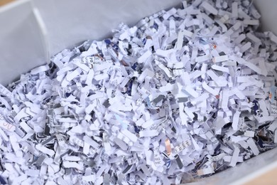 Photo of Shredded paper strips in bin, closeup view