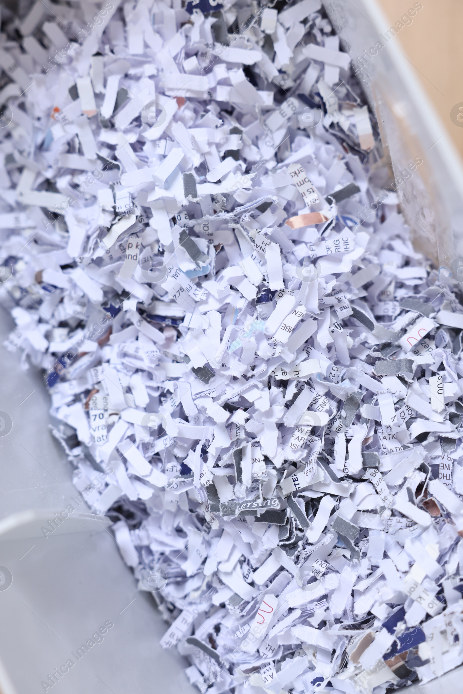 Photo of Shredded paper strips in bin, closeup view