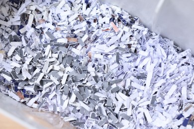 Photo of Shredded paper strips in bin, closeup view