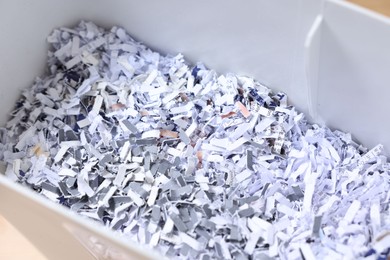 Photo of Shredded paper strips in bin, closeup view