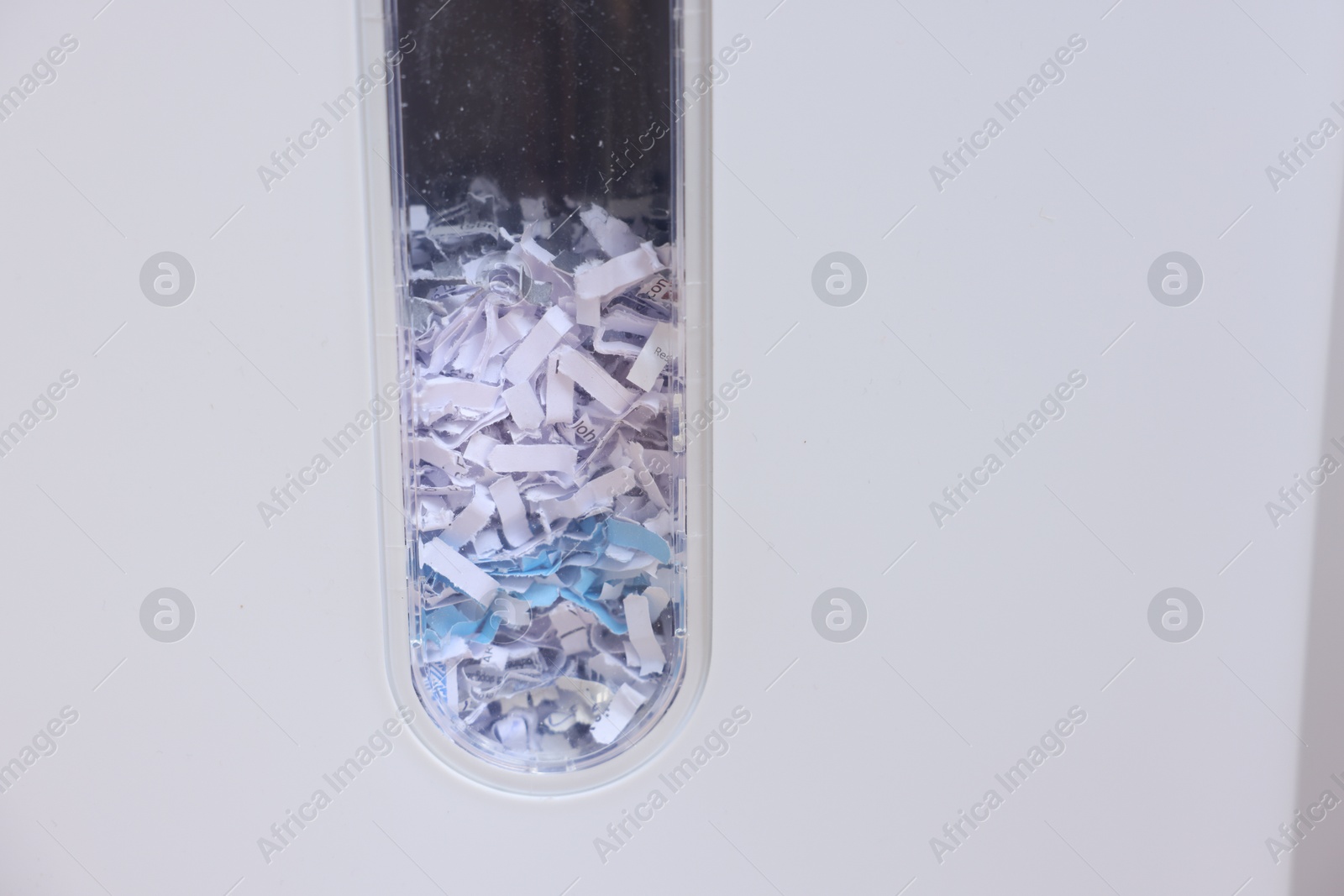 Photo of Closeup view of shredder with paper strips