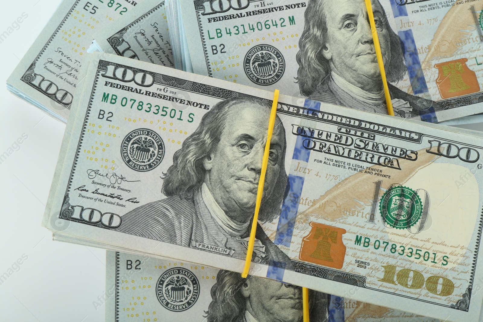 Photo of Many dollar banknotes on white background, top view