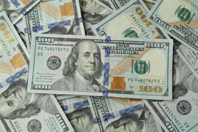 Photo of Many dollar banknotes as background, top view