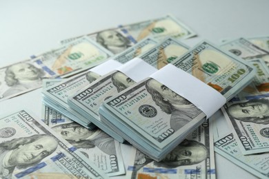 Photo of Many dollar banknotes on light background, closeup