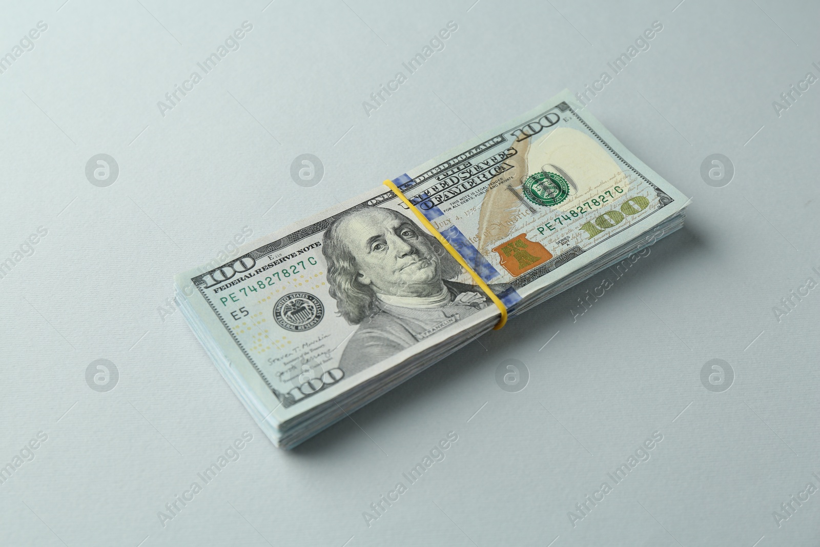 Photo of Dollar banknotes on grey background. American currency