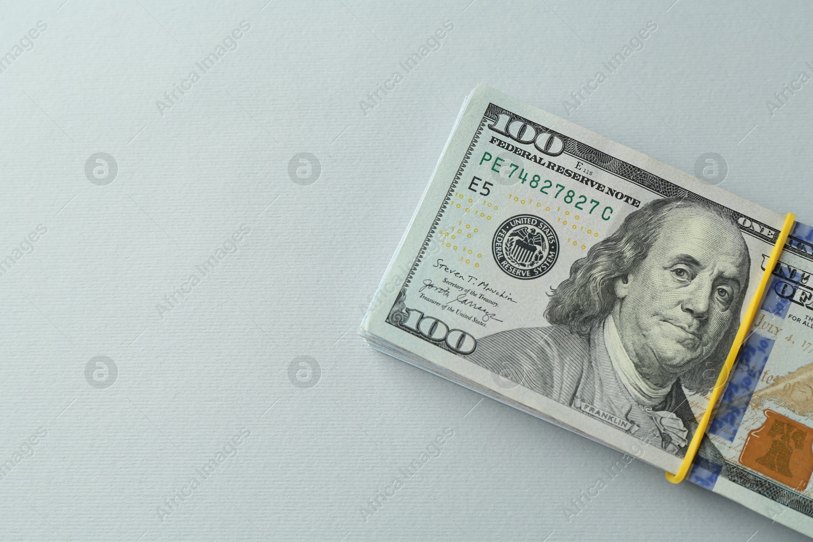 Photo of Dollar banknotes on grey background, top view. Space for text