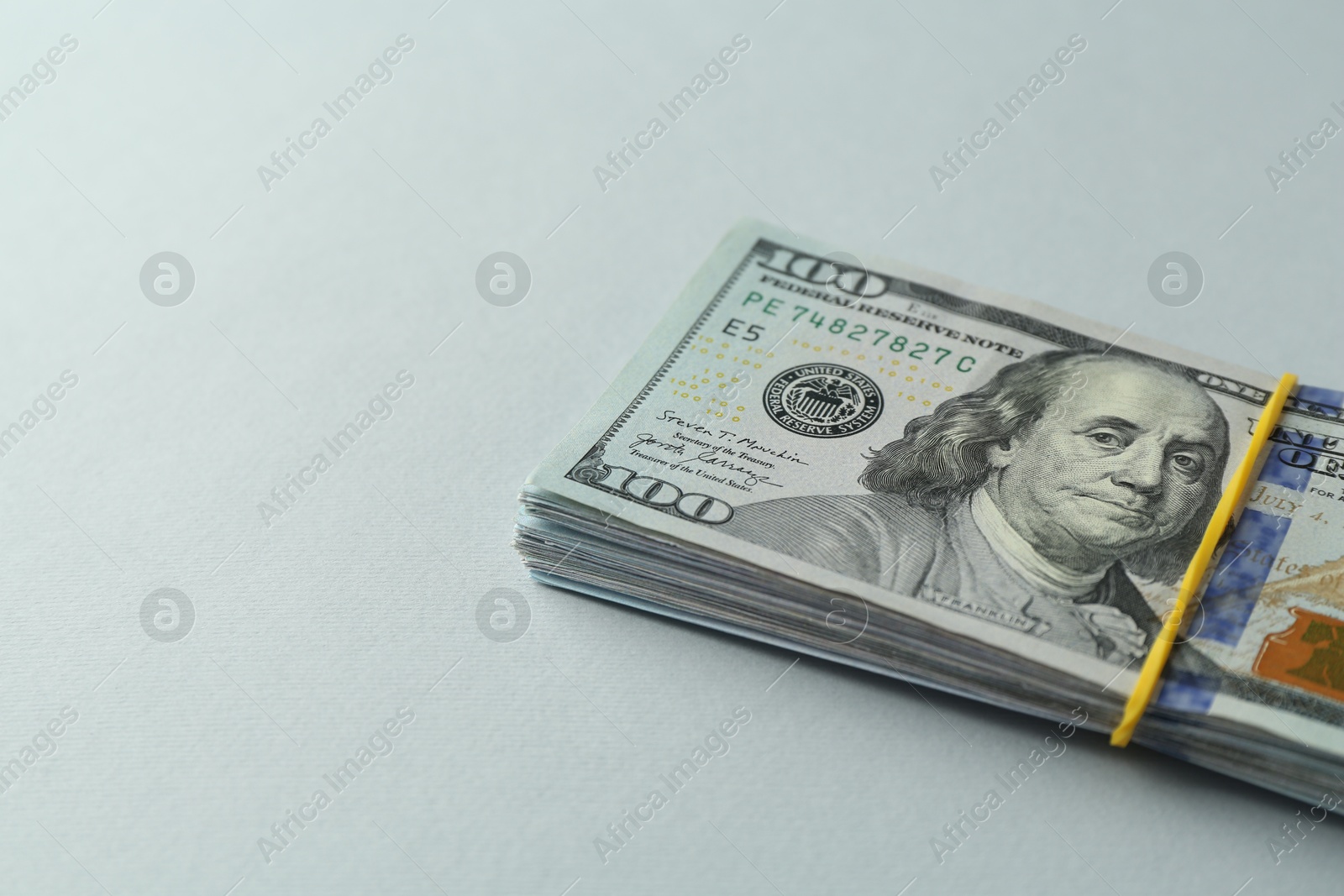 Photo of Dollar banknotes on grey background, closeup. Space for text