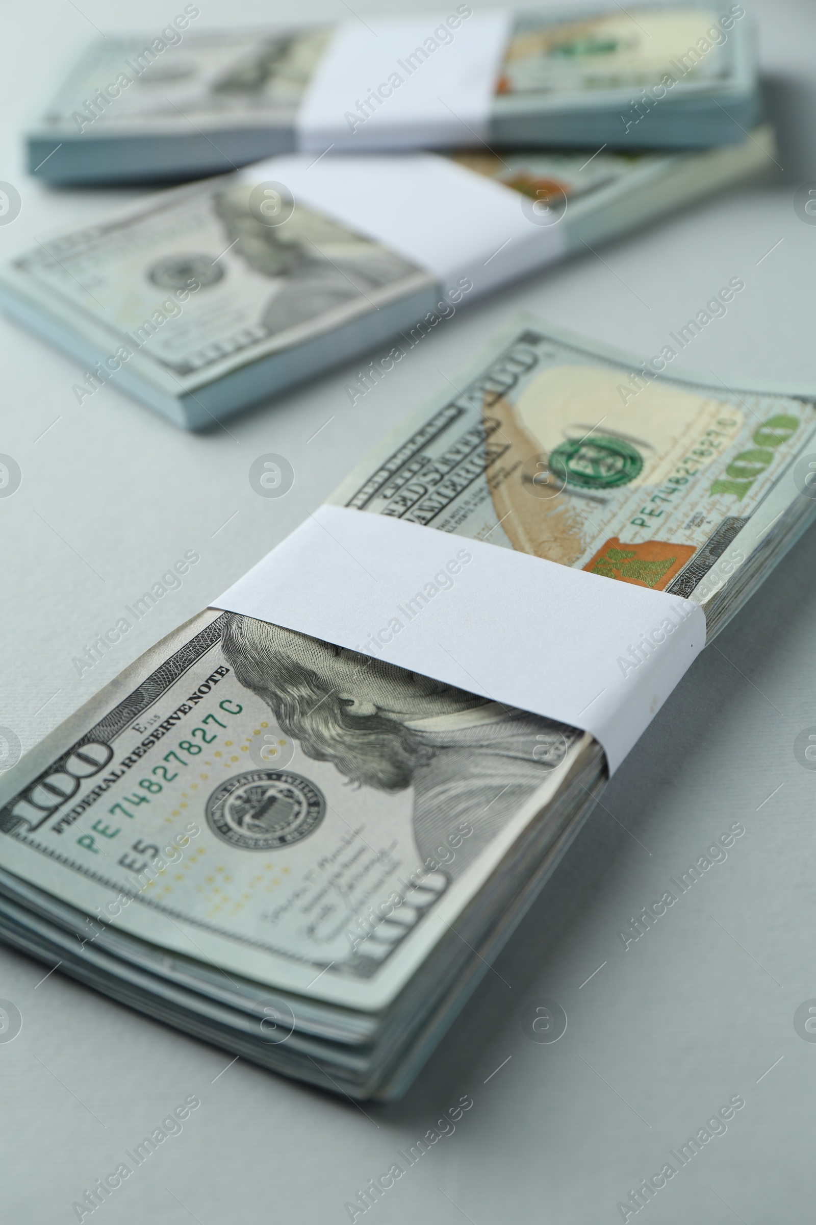 Photo of Dollar banknotes on grey background, closeup. American currency