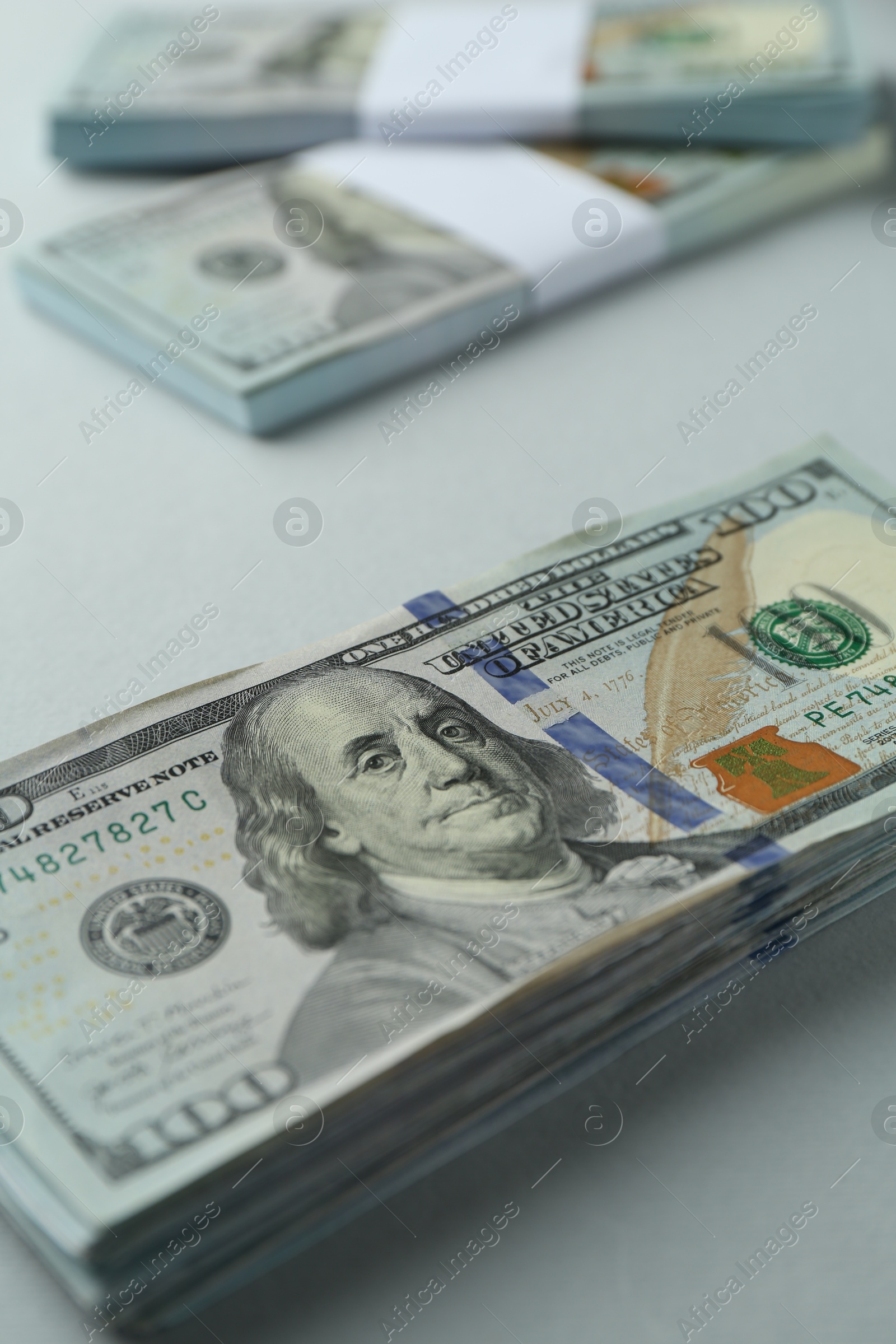 Photo of Dollar banknotes on grey background, closeup. American currency