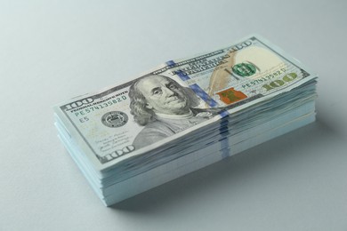 Stack of dollar banknotes on grey background, closeup