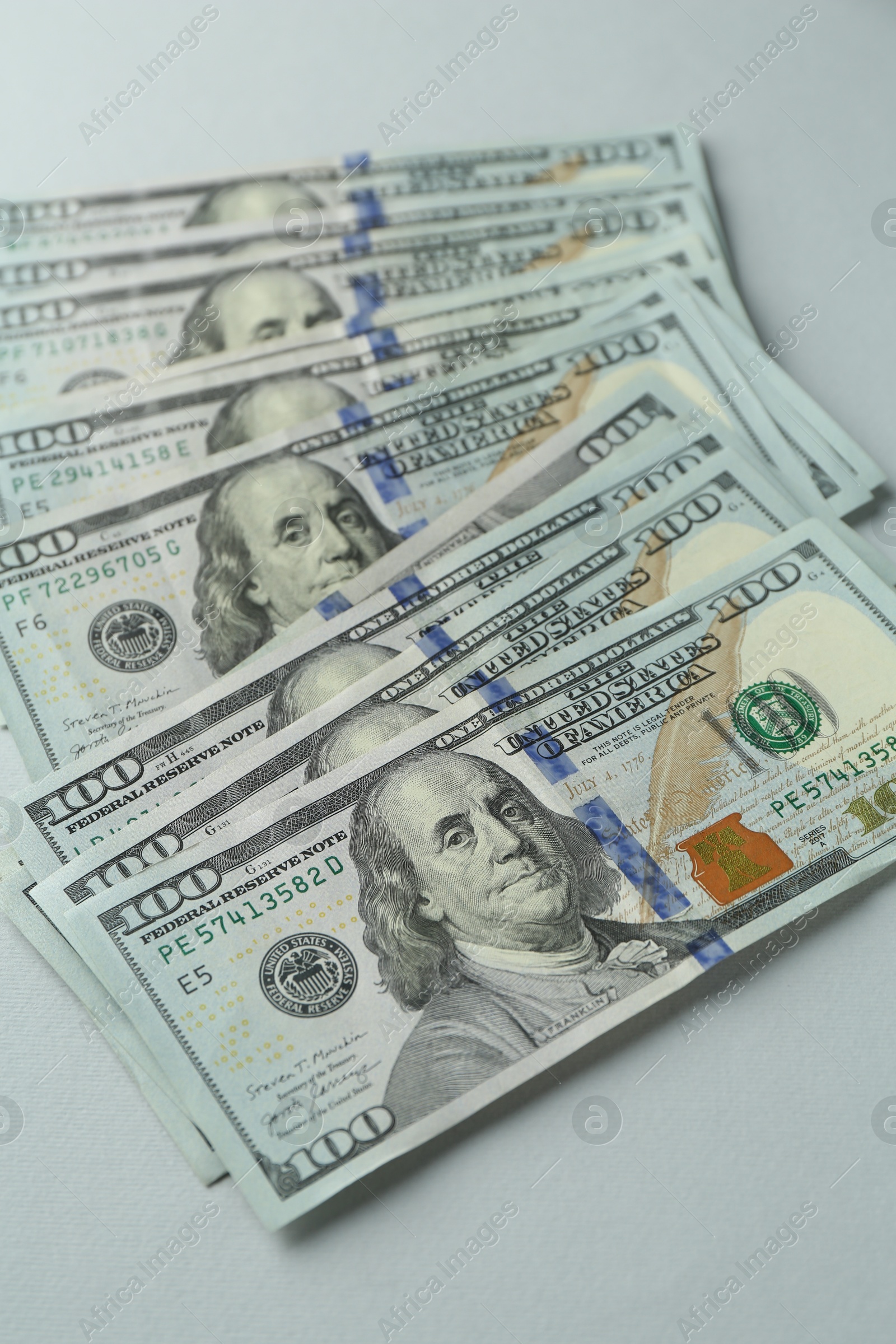 Photo of Dollar banknotes on grey background, above view. American currency