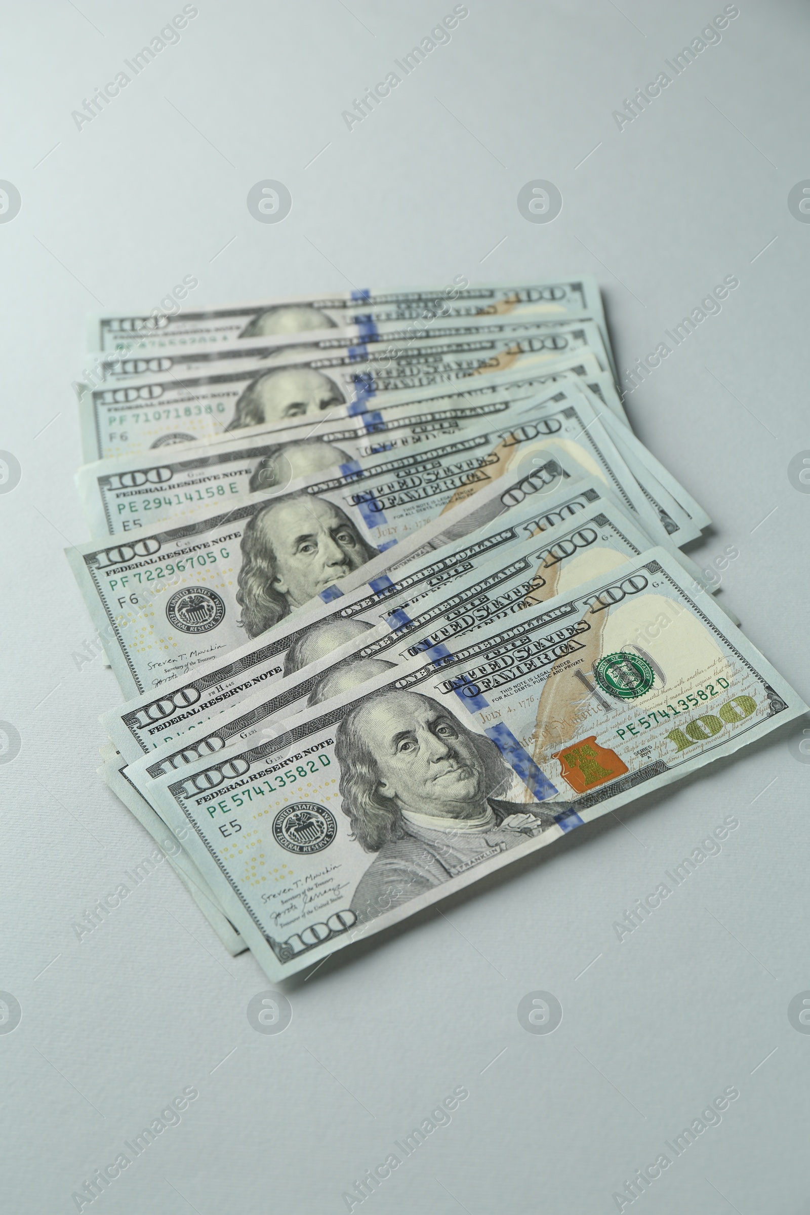 Photo of Dollar banknotes on grey background, above view. American currency