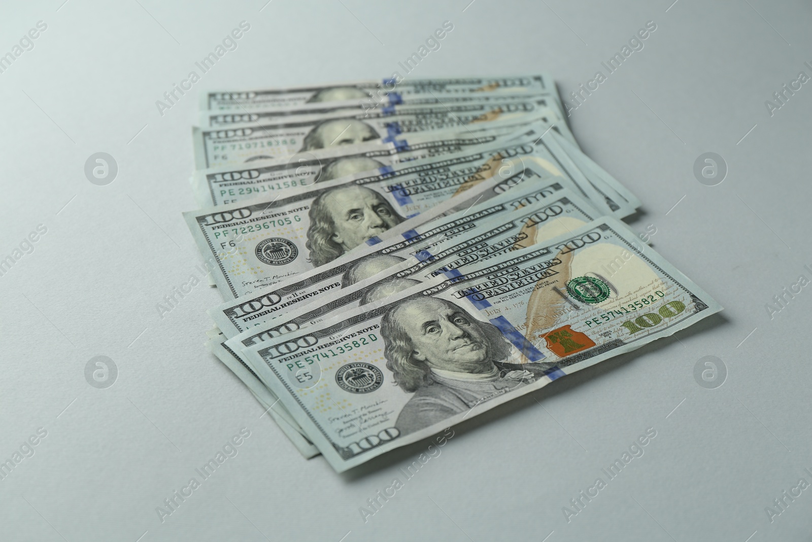 Photo of Dollar banknotes on grey background. American currency