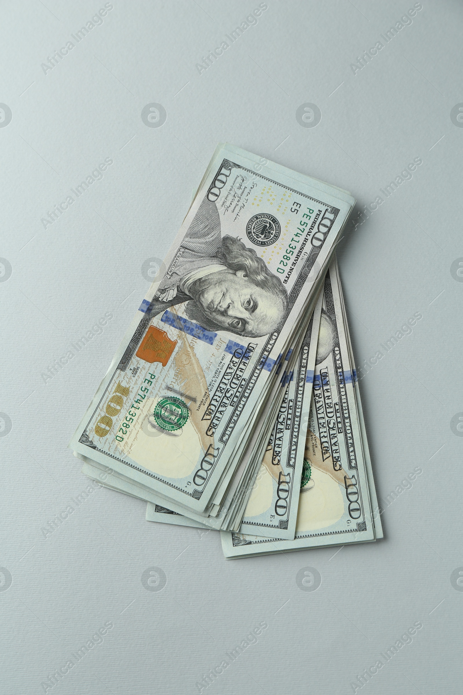 Photo of Dollar banknotes on grey background, top view