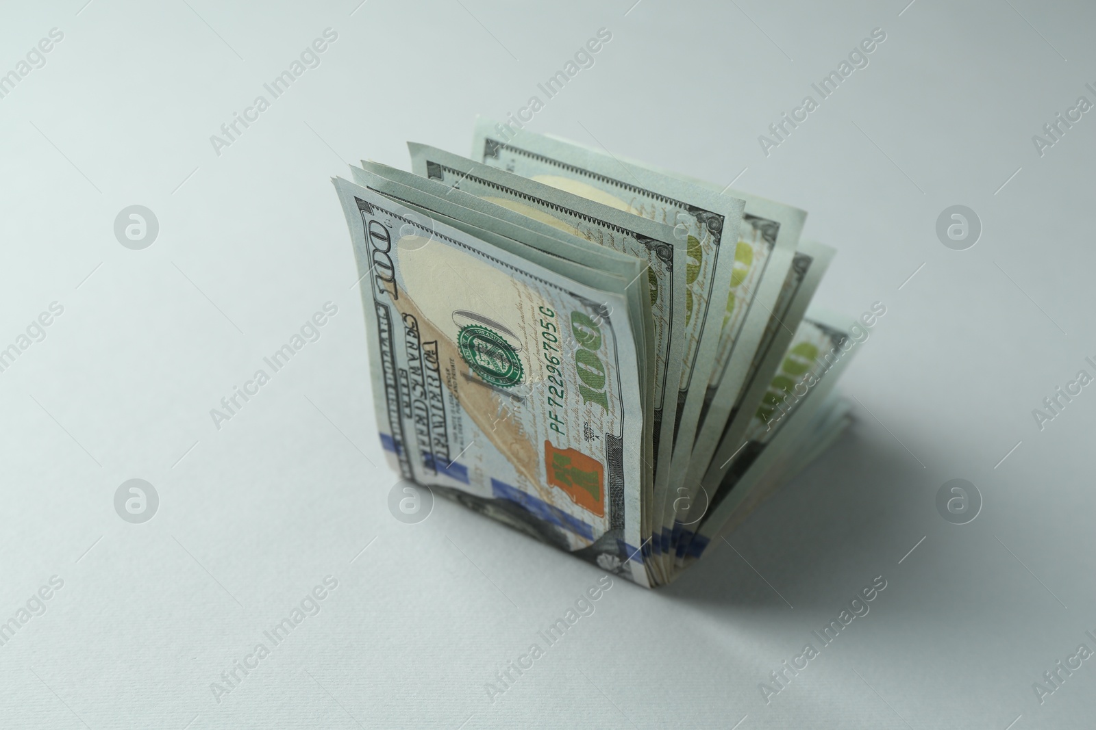 Photo of Dollar banknotes on grey background, closeup. American currency