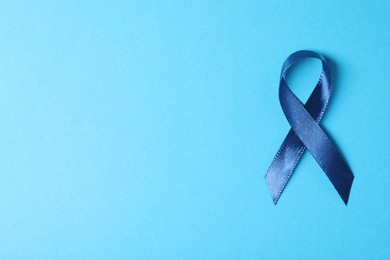 Dark blue ribbon on color background, top view with space for text. Prostate cancer awareness