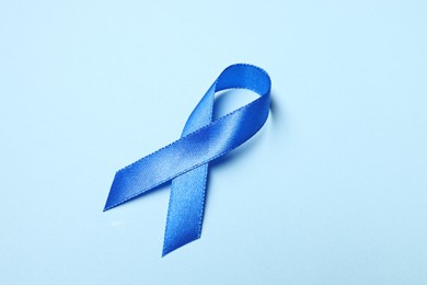 Photo of Blue ribbon on light background. Prostate cancer awareness