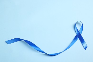 Photo of Blue ribbon on light background, top view with space for text. Prostate cancer awareness