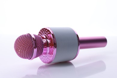 Photo of One pink karaoke microphone isolated on white