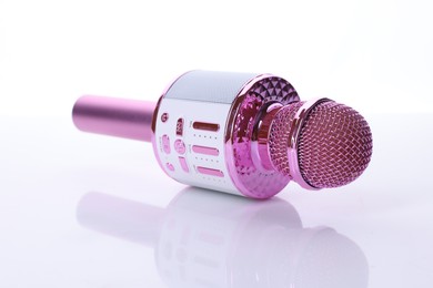 Photo of One pink karaoke microphone isolated on white