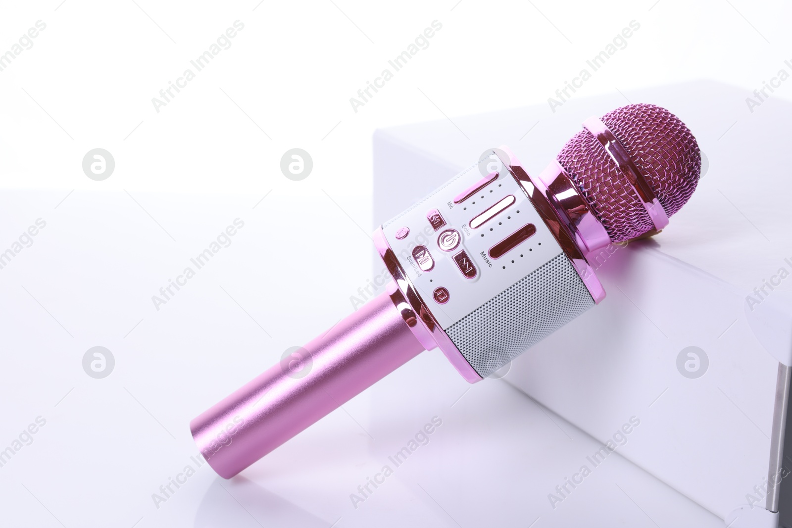 Photo of One pink karaoke microphone isolated on white