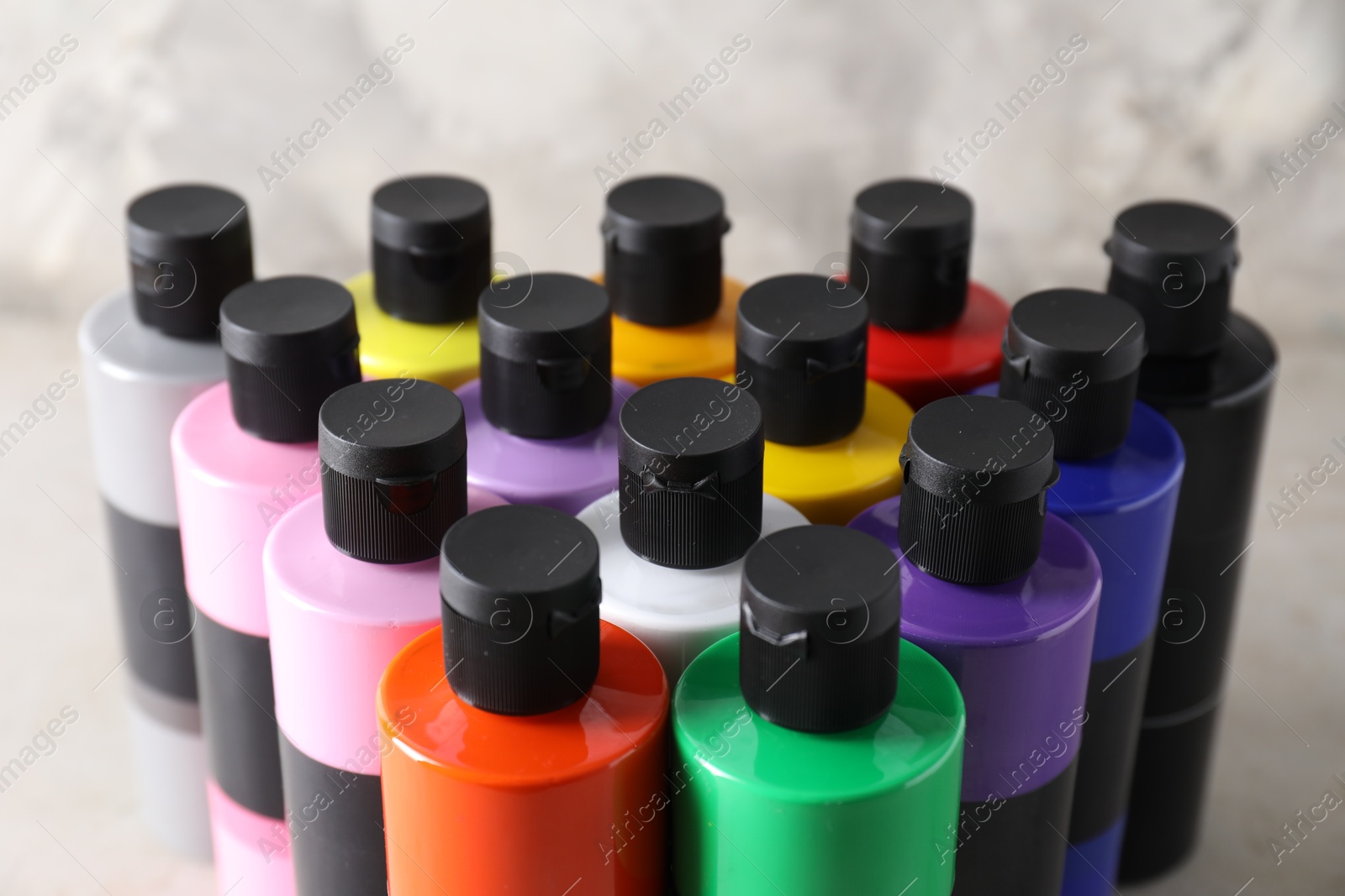 Photo of Acrylic paints of different colors on table, closeup