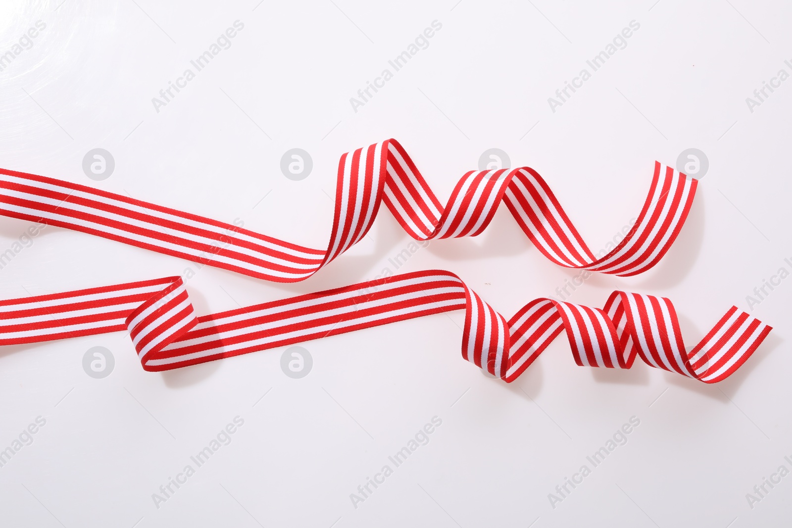 Photo of Striped ribbons isolated on white, top view