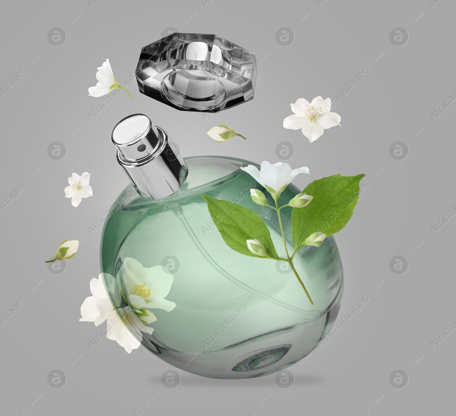 Image of Bottle of floral perfume and jasmine flowers in air on grey background