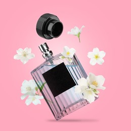 Image of Bottle of floral perfume and jasmine flowers in air on pink background