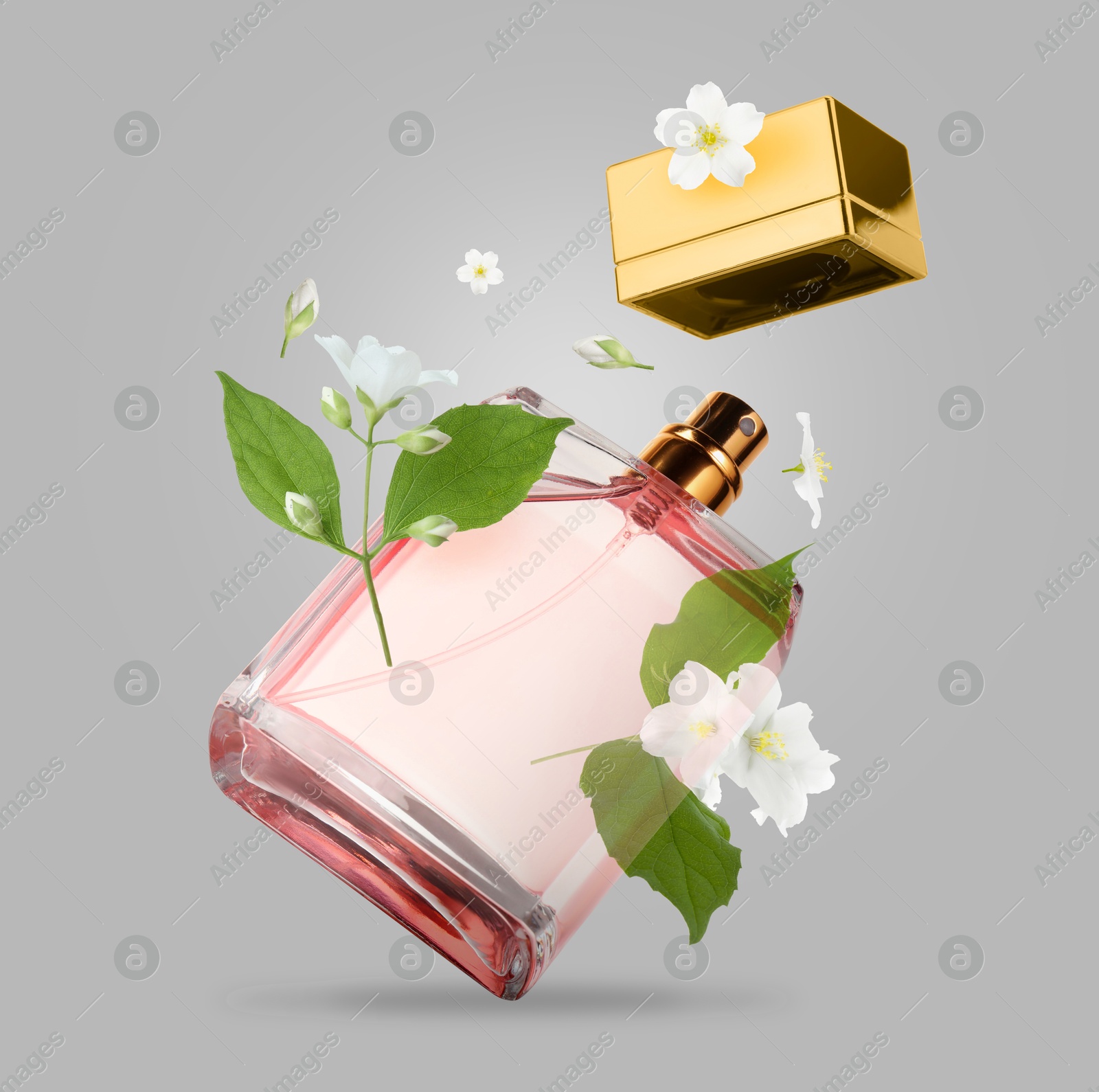 Image of Bottle of floral perfume and jasmine flowers in air on grey background