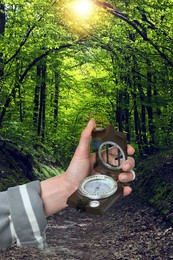 Image of Woman holding compass in green forest, closeup