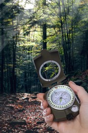 Woman holding compass in lush forest, closeup