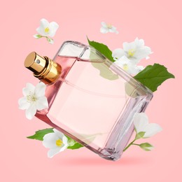 Image of Bottle of floral perfume and jasmine flowers in air on pink background