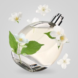 Image of Bottle of floral perfume and jasmine flowers in air on light grey background