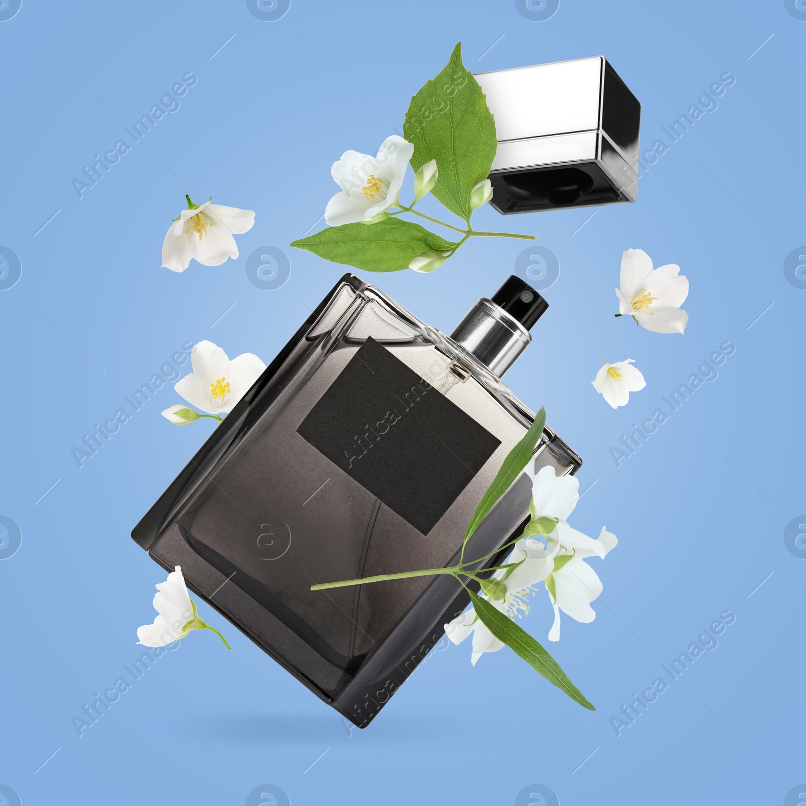 Image of Bottle of floral perfume and jasmine flowers in air on light blue background