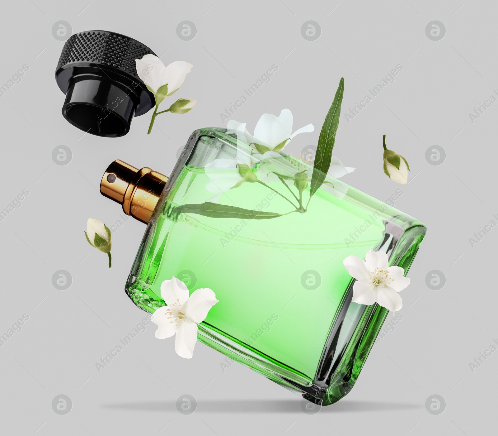 Image of Bottle of floral perfume and jasmine flowers in air on light grey background