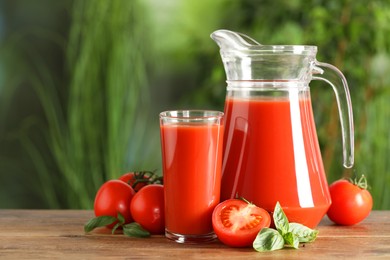 Photo of Tasty tomato juice, basil and fresh vegetables on wooden table outdoors. Space for text