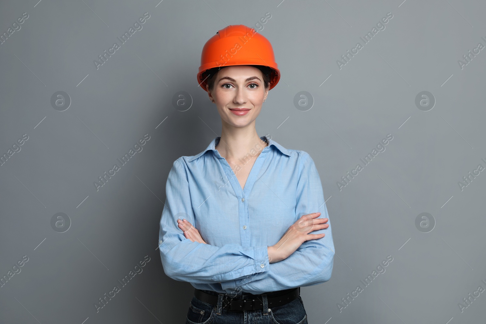 Photo of Engineer in hard hat on grey background