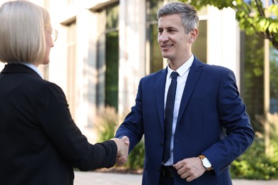 International relations. Diplomats shaking hands during meeting outdoors