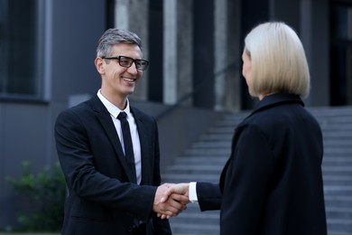 International relations. Diplomats shaking hands during meeting outdoors