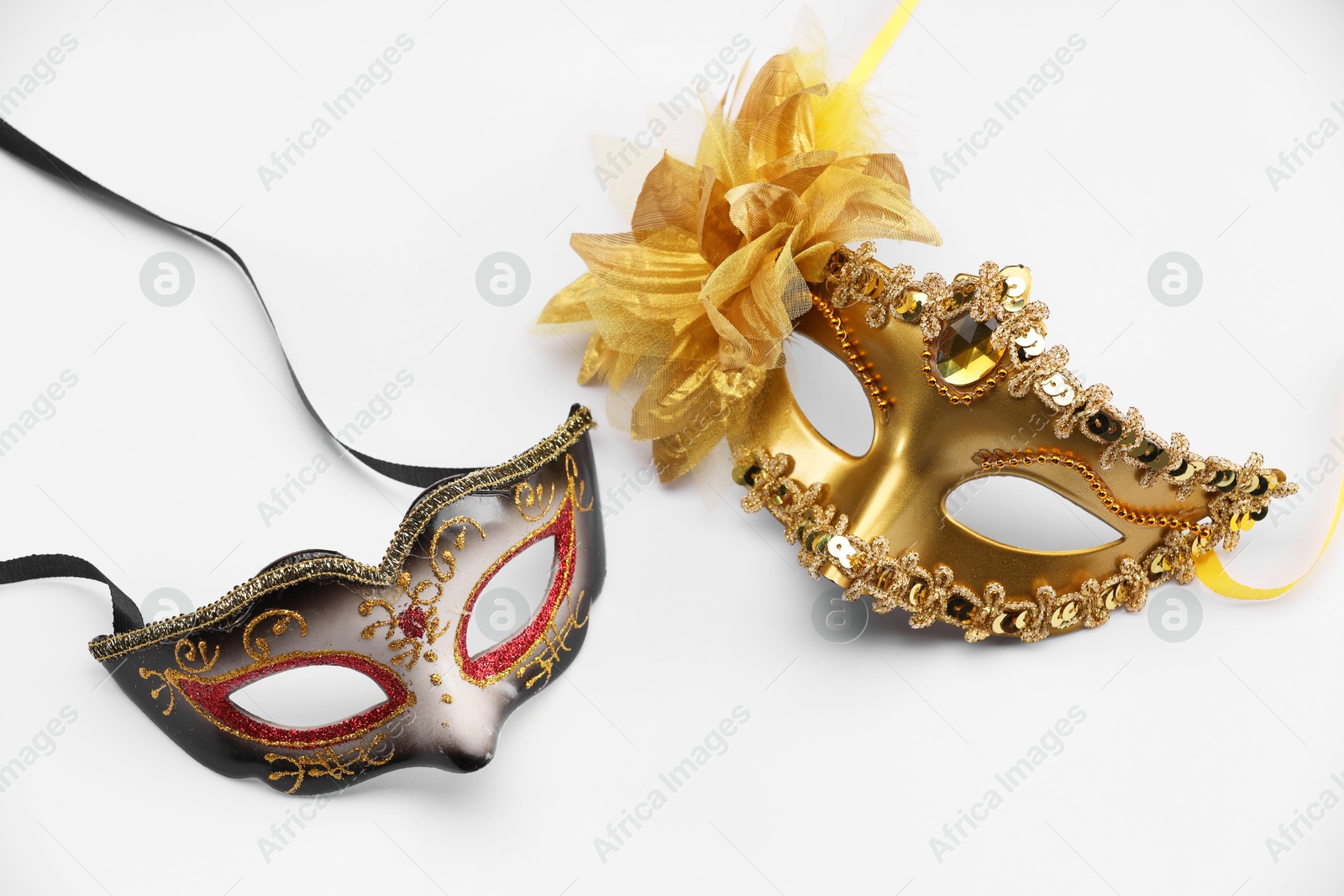 Photo of Elegant face masks on white background. Theatrical performance