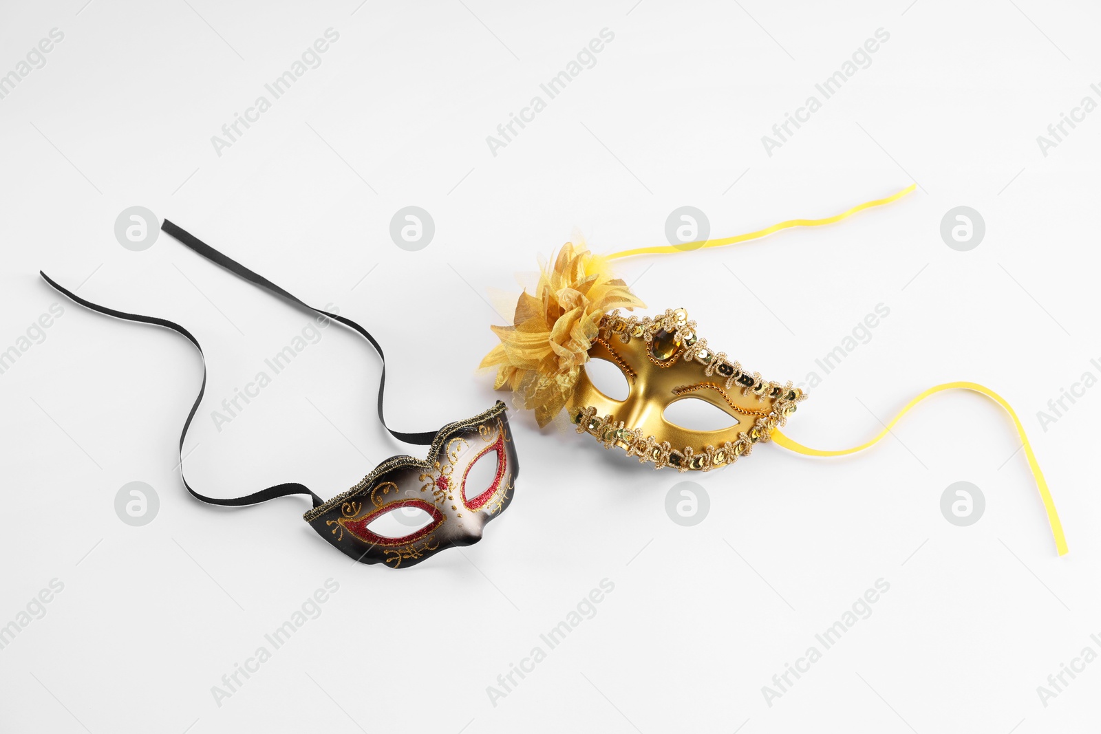 Photo of Elegant face masks on white background. Theatrical performance